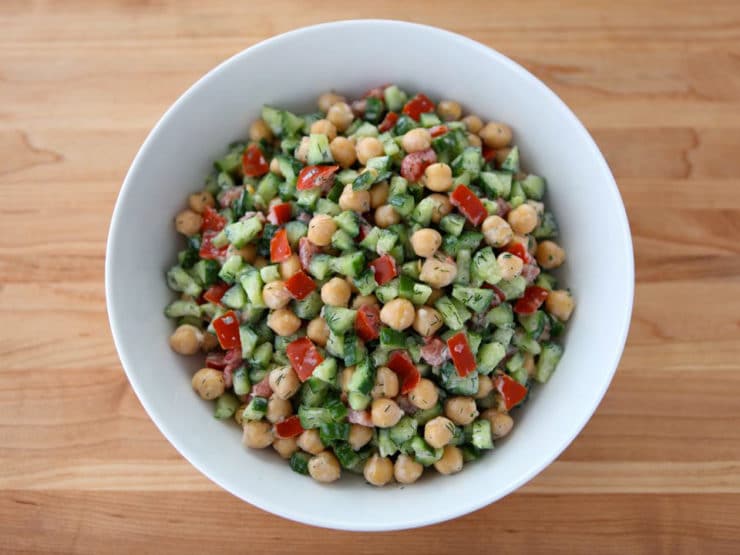 Creamy Israeli Salad with Dill - A creamy twist on Israeli Salad with Persian cucumbers, tomatoes, chickpeas, Greek yogurt, lowfat sour cream, fresh dill, and lemon juice.