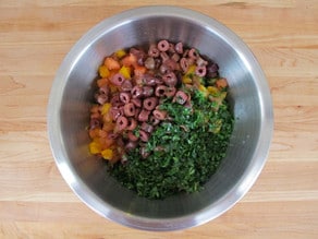 Chopped salad ingredients in a mixing bowl.