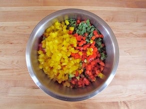 Diced bell peppers and mint in a large mixing bowl.
