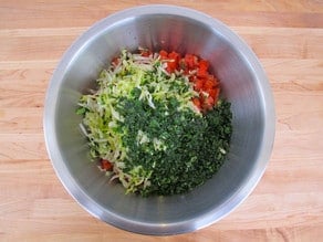 Chopped salad ingredients in a mixing bowl.