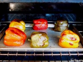 Colorful bell peppers blackened on baking sheet.
