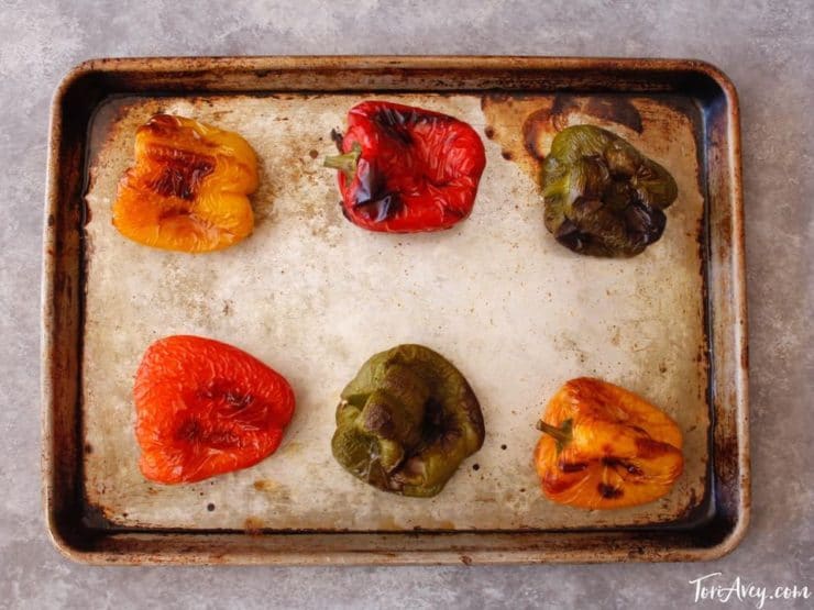Colorful bell peppers blackened on baking sheet.