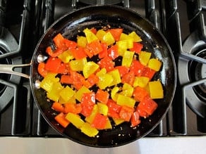 Chopped bell pepper in a skillet.