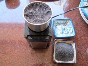 Grinding poppy seeds in a coffee grinder.