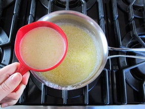 Remove one cup of hot butter from the saucepan.