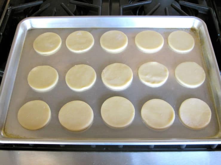 Cookie dough circles on a baking sheet.