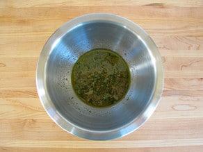 Whisked vinegar dressing in a small bowl.