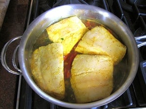 Fish fillets in a large saute pan.