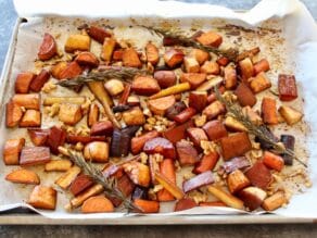 Roasted root veggies on tray with rosemary