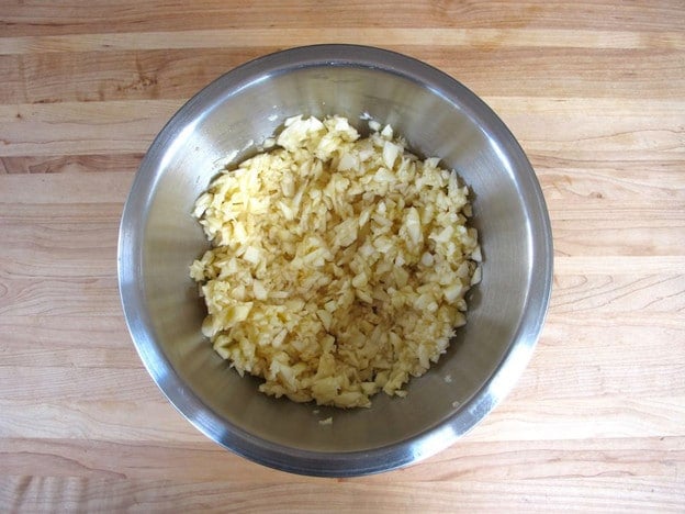 MInced apples in a mixing bowl.