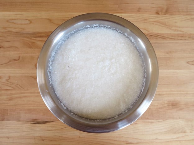 Dried coconut soaking in a bowl of water.