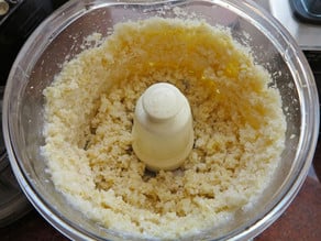 Pulsing almonds in a food processor.