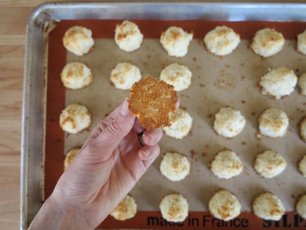 Checking macaroon bottoms for doneness.