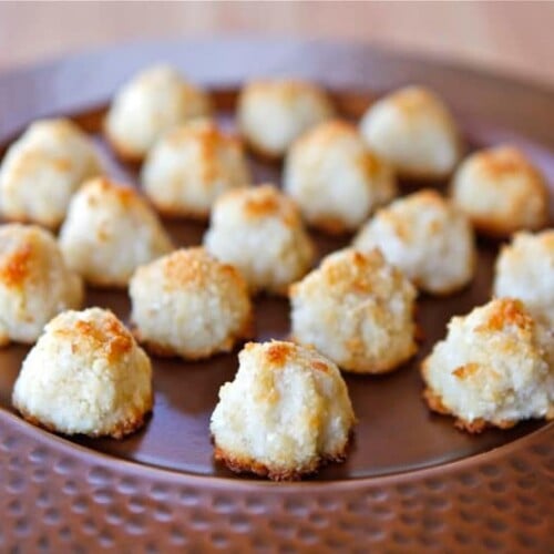 A plateful of Lemony Almond Macaroons on top of a wooden table