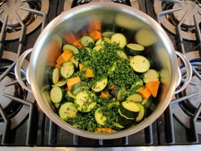 Diced vegetables in a stockpot.