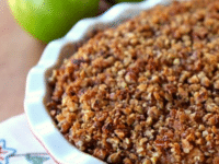 White dish filled with apple pecan pie, made with green apples and chopped pecans