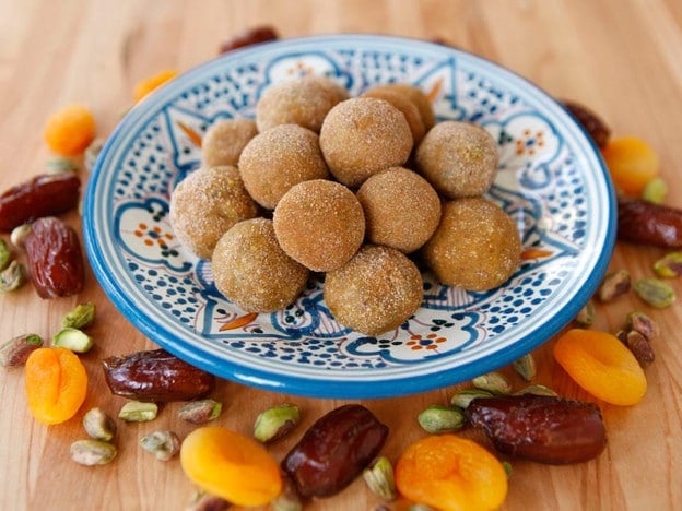 A plate of dates and nuts on wooden table, Sephardic Charoset Truffles