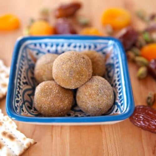 A plate of dates and nuts on wooden table, Sephardic Charoset Truffles