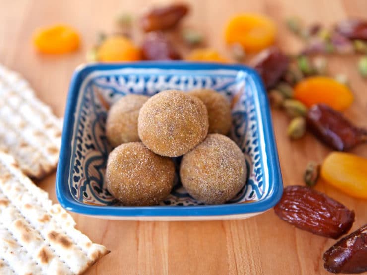 A plate of dates and nuts on wooden table, Sephardic Charoset Truffles
