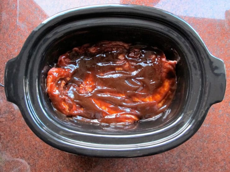 Barbecue sauce covered brisket in the slow cooker.