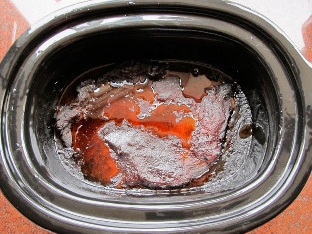 Cooked beef brisket in the slow cooker.