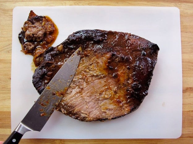 Slice off the fat cap of the beef brisket.