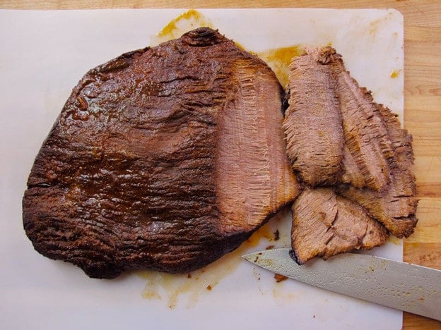 Slicing beef brisket against the grain.
