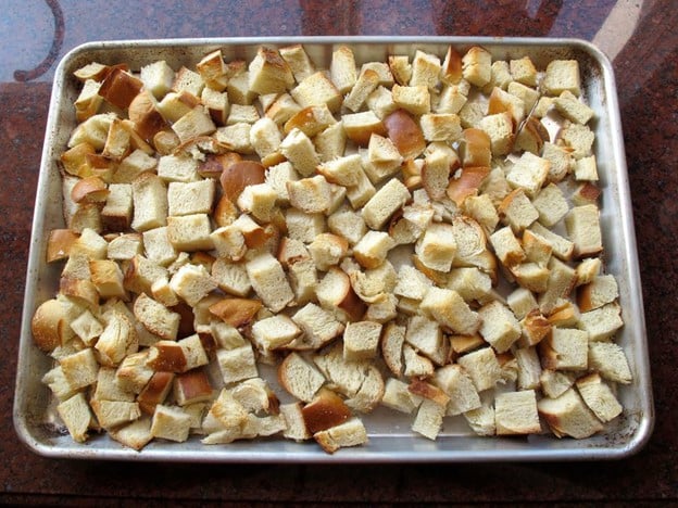 Challah cubes on a baking sheet.