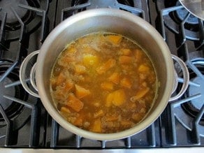 Simmering soup in a stockpot.