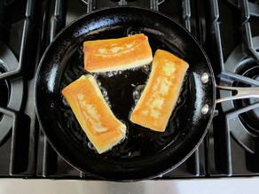 Frying blintzes in a skillet.
