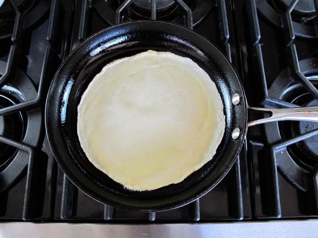Blintz batter in a hot skillet.