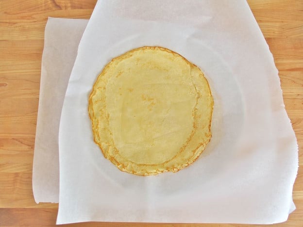 Blintzes set on parchment paper to cool.