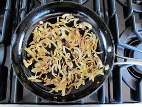 Sliced onions in a skillet.