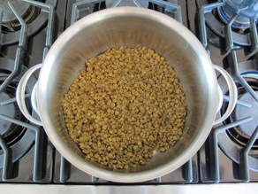Cooked lentils in a saucepan.