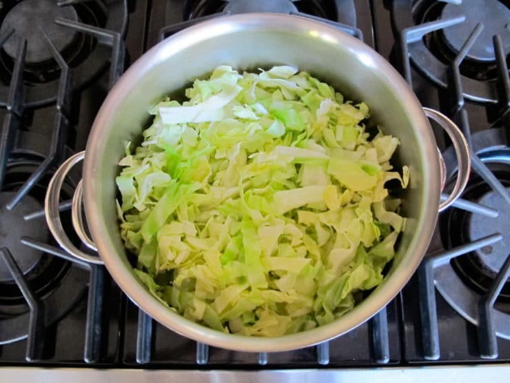 Sliced cabbage in a pot of boiling water.
