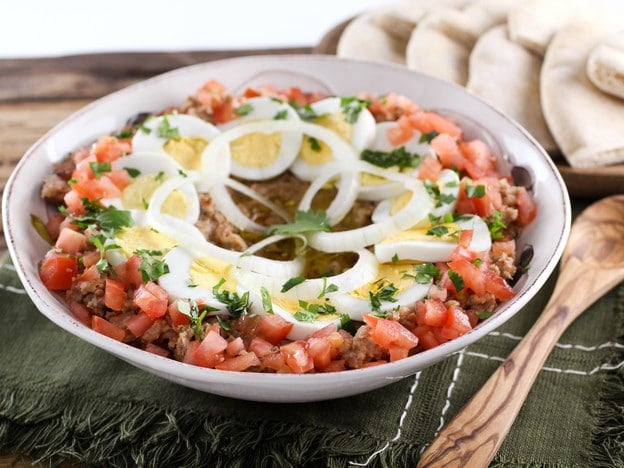 Slant shot of Ful Mudammas, a traditional Middle Eastern dish made with cooked fava beans