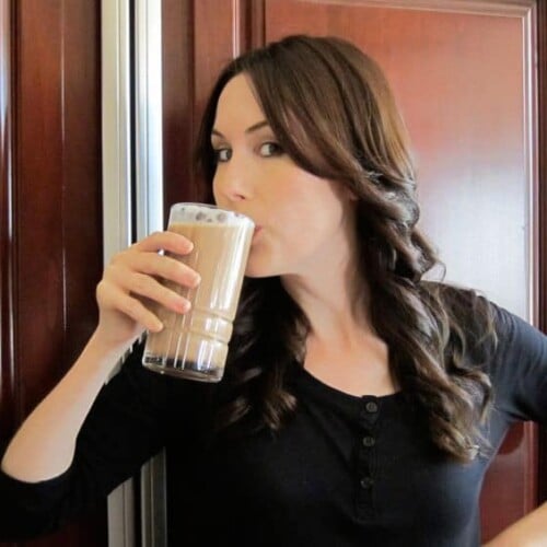 Tori Avey drinking a delicious chocolate egg cream in a tall glass