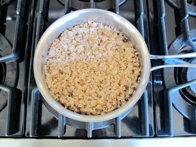 Heating kasha in a saucepan.