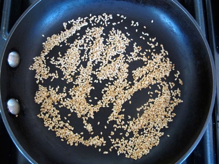 Dry toasting sesame seeds in a skillet.
