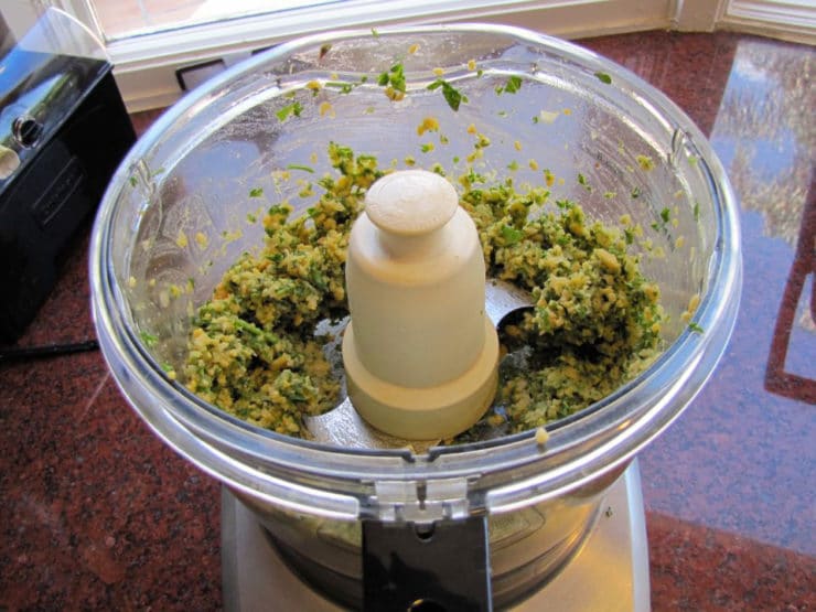 Chickpeas and seasoning in a food processor.