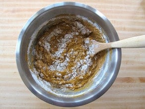 Stirring flour into wet challah ingredients.