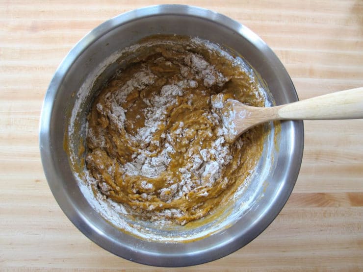 Stirring flour into wet challah ingredients.