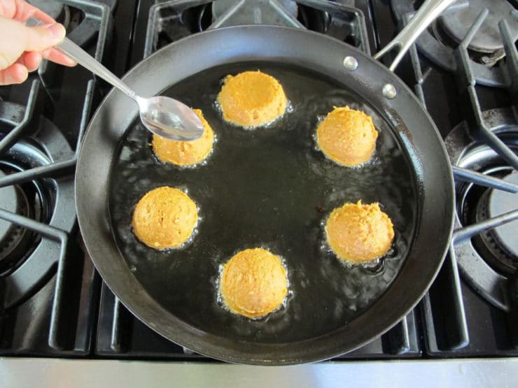 Frying chremslach in a skillet.
