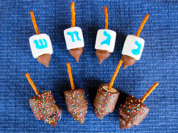 Candy dreidels with Hebrew letters and chocolate dipped with sprinkles.