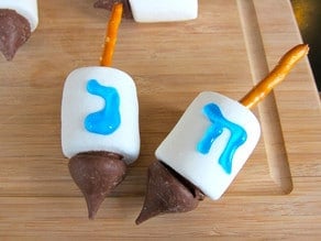 Two candy dreidels with Hebrew letters.