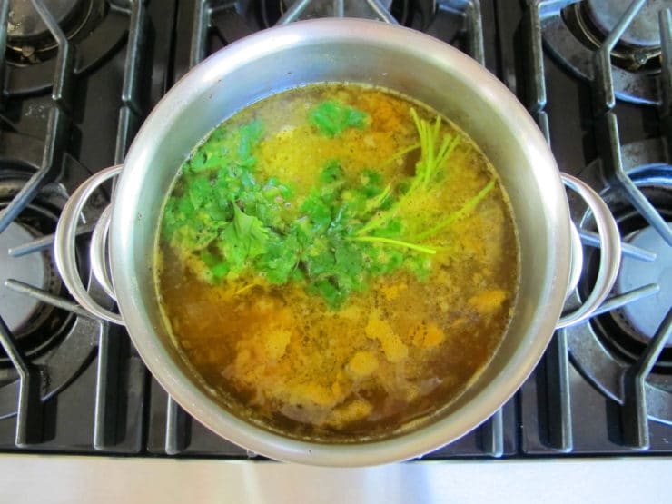 Cilantro bunch added to simmering soup.
