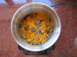Unprocessed spices in coffee grinder.