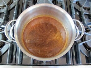 Boiling butter and sugar in a saucepan.