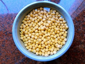 Large bowl of chickpeas soaking on countertop.