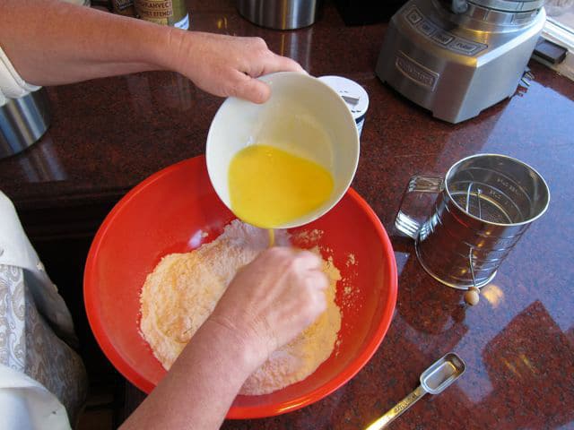 Stirring egg yolk into flour.